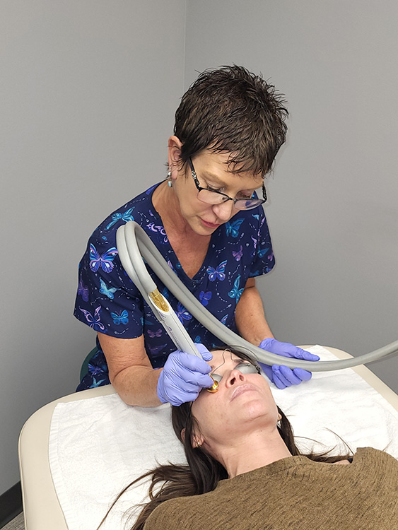 Joanne Bohonyi doing a Laser Skin Rejunivation treatment on a client